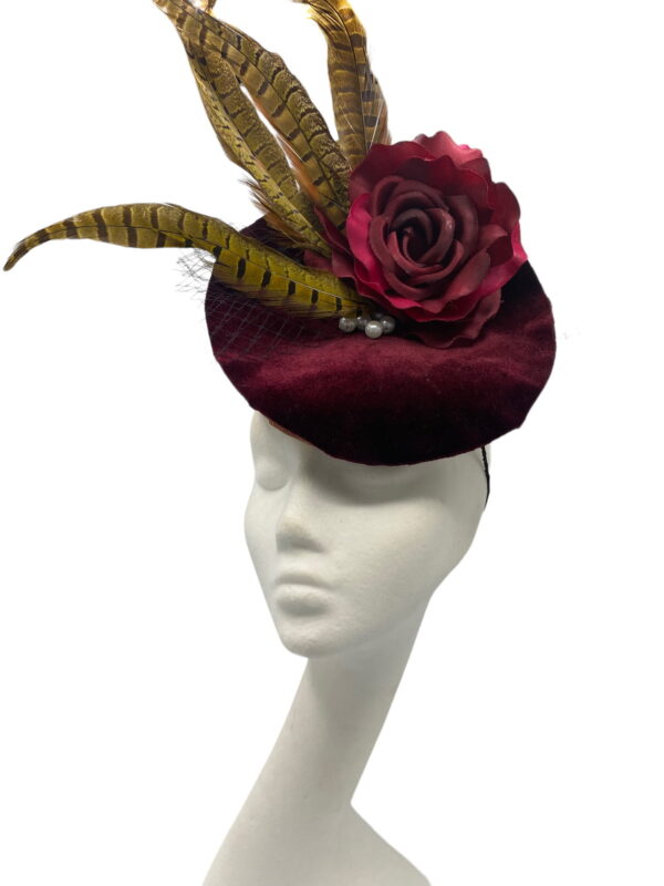 Wine/burgundy coloured percher hat with wine/burgundy flower and finished in fab feather detail.